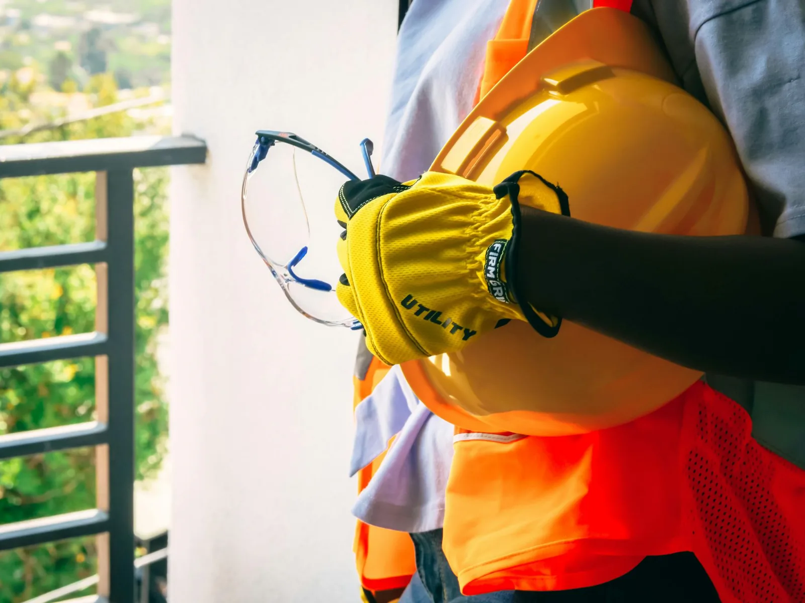 QDBI team member in a hard hat and safety glasses on a job site